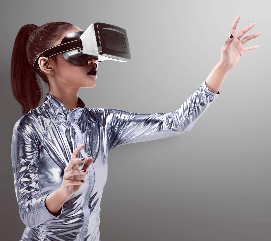 Woman in silver latex costume and VR headset